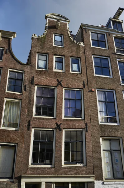 Holland, Amsterdam, the facade of old private stone houses — Stock Photo, Image
