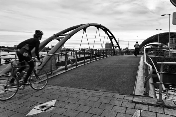 stock image Holland, Amsterdam, bikers on a bridge