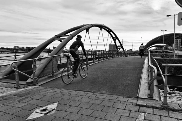 stock image Holland, Amsterdam, bikers on a bridge