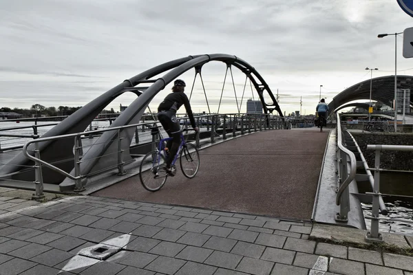 stock image Holland, Amsterdam, bikers on a bridge