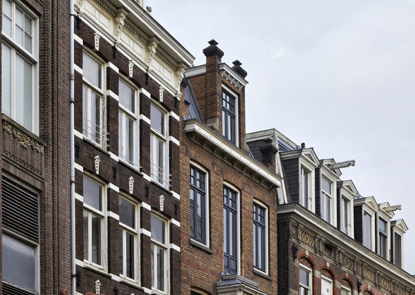Holland, Amsterdam, the facade of old private stone houses downtown