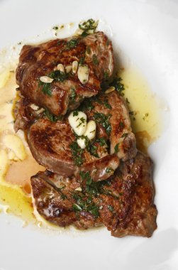 Grilled tenderloin steak served with a garlic clipart