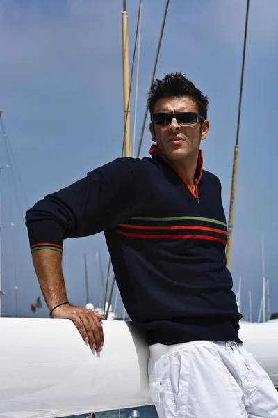 Italy, Tuscany, young model dressed casual on a sailing boat Stock Photo