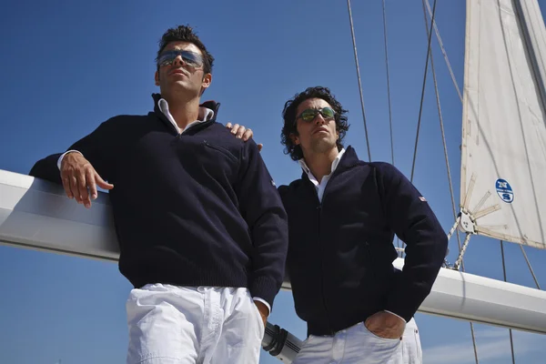 Italy, Tuscany, young sailors dressed casual on a sailing boat Stock Image