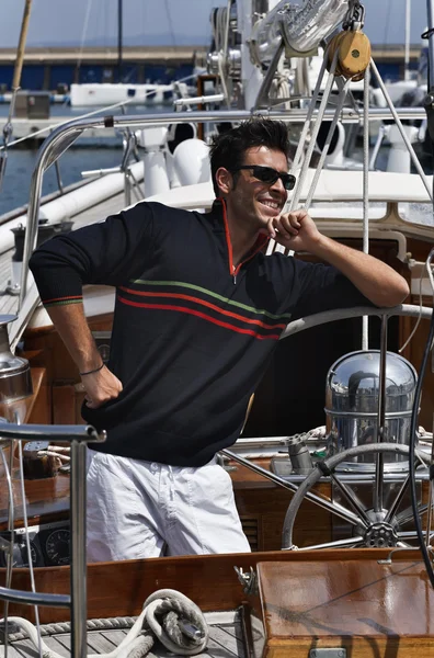 Italy, Tuscany, young sailor dressed casual on a sailing boat Royalty Free Stock Images