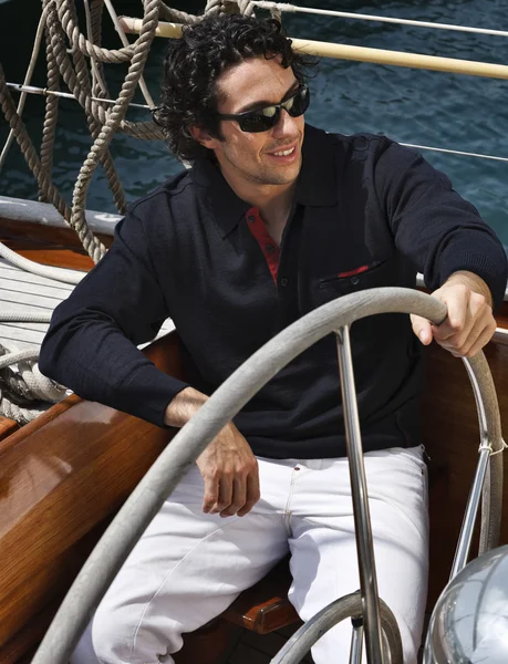 Italy, Tuscany, young sailor on a wooden sailing boat Royalty Free Stock Photos