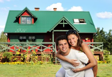 Young couple and their house clipart