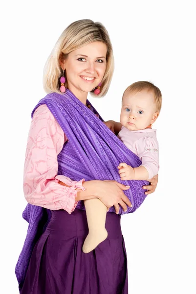 Young mother with baby in sling isolated on white studio background — Stock Photo, Image