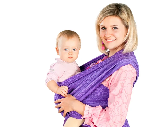 Young mother with baby in sling isolated on white studio background — Stock Photo, Image