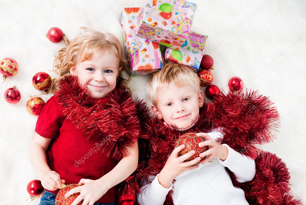 Cute siblings enjoying Christmas gifts