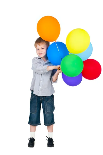Happy boy standing with balloons isolated on white background — Stock Photo, Image
