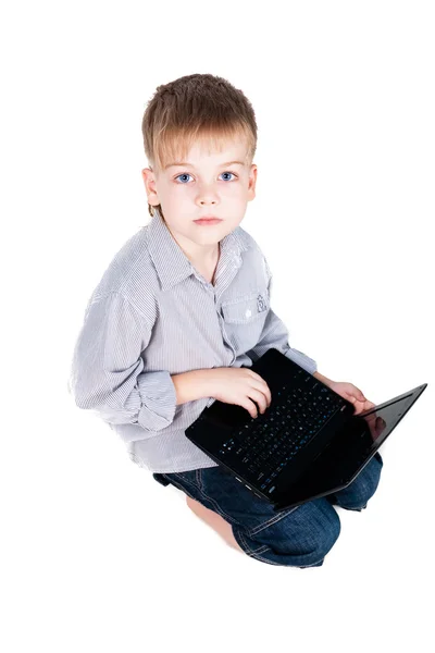 Little schoolboy learning with laptop isolated on white background — Stock Photo, Image