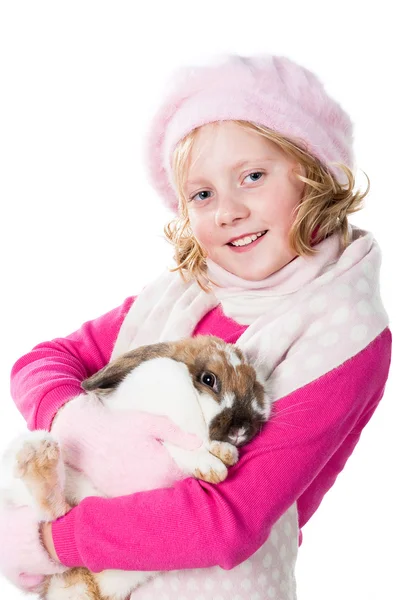 Carino giovanissima ragazza in inverno vestito holding coniglio isolato su bianco — Foto Stock
