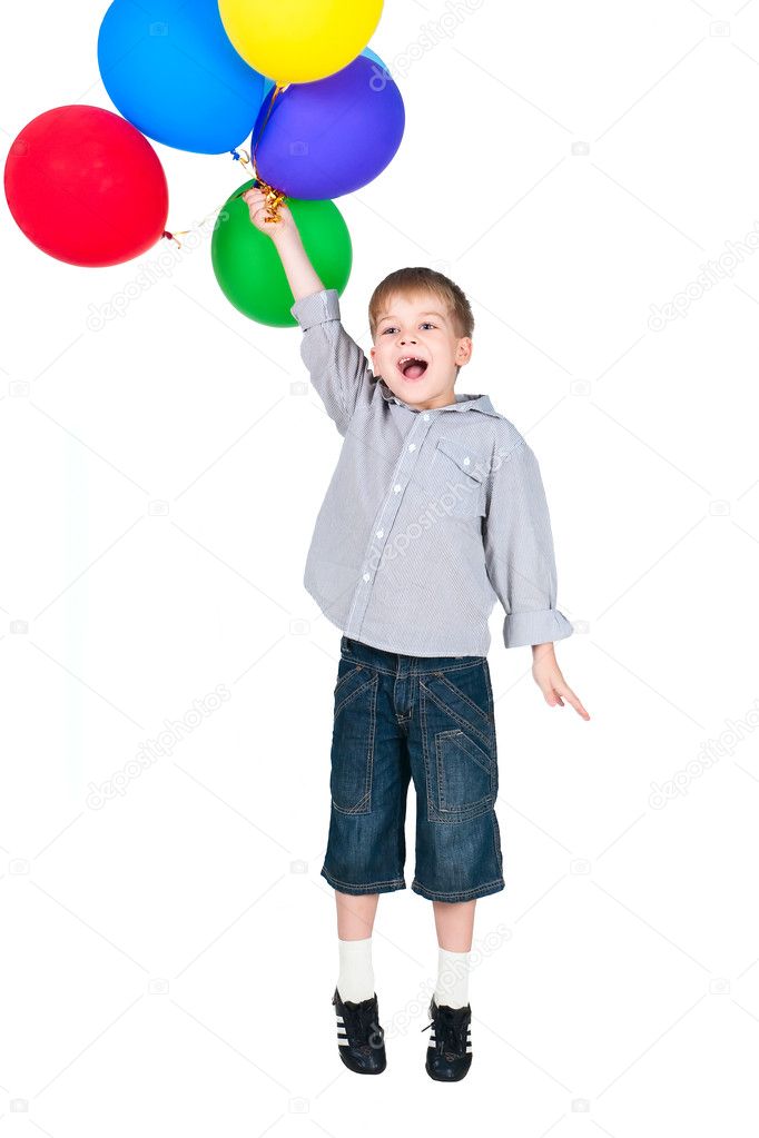 Exited happy boy jumpind with balloons isolated on white