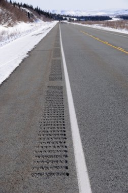 Rumble Strips on Alaska Highway in Winter clipart