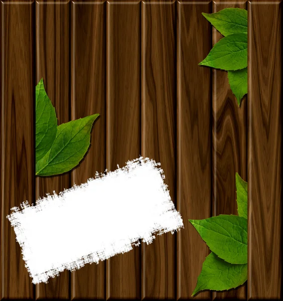 Wooden background with green leaves