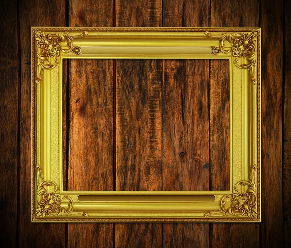 Old antique gold frame on wood background — Stock Photo, Image