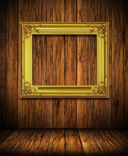 Old antique gold frame on wood wall — Stock Photo, Image