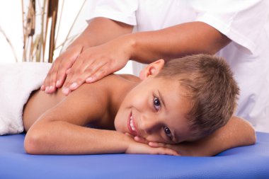 Smiling boy with the physiatrist in therapy clipart