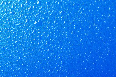 Blue background texture covered with water drops clipart