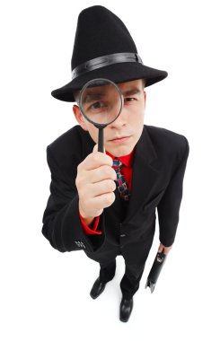 Serious detective looking through magnifying glass clipart