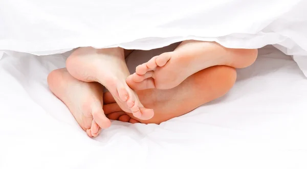 Feet showing under the quilt — Stock Photo, Image