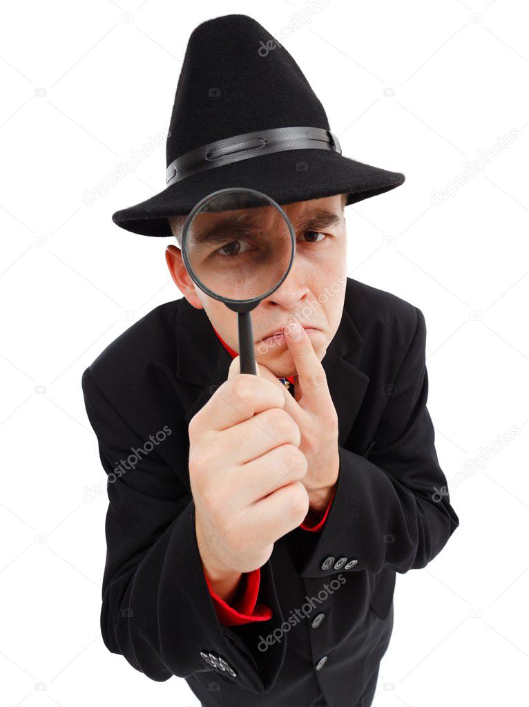 Sceptical detective looking through magnifying glass