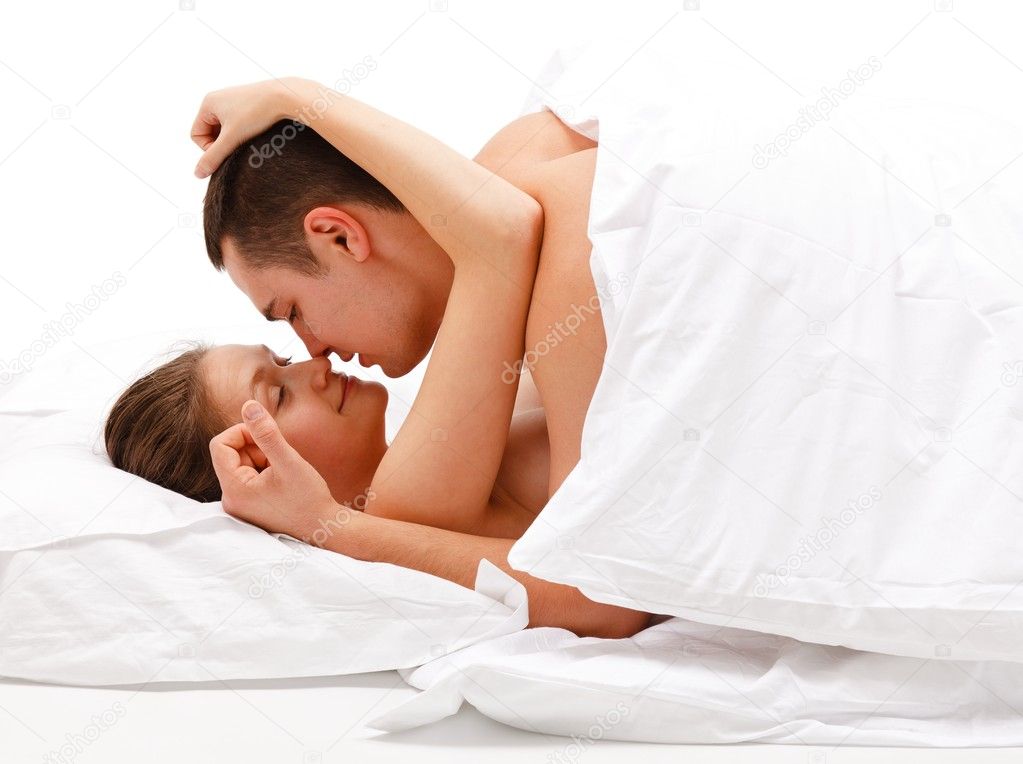 Young couple caressing each other in bed