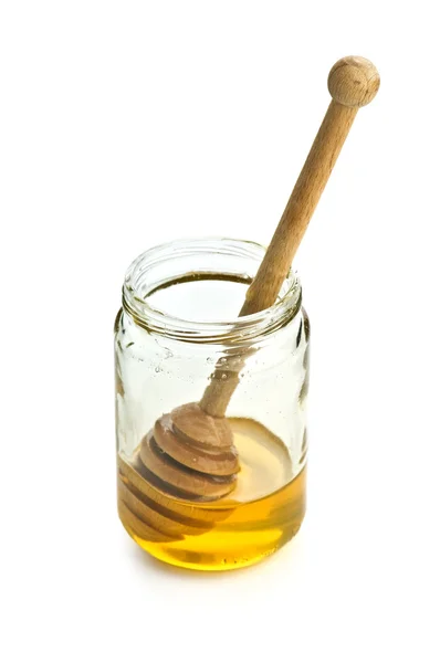 Мед в стеклянной банке изолирован — стоковое фото