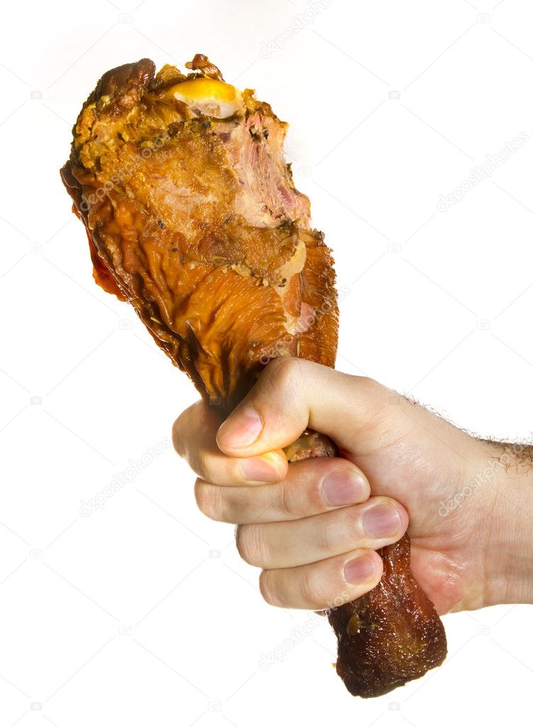 Bitten Turkey Leg On Male Hand. Over white.