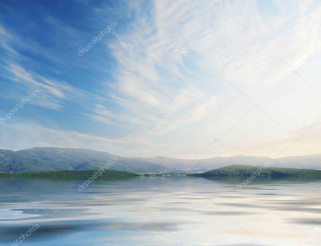 Blue sky with sun over water