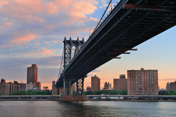 Manhattan Bridge closeup in the morning with colorful cloud over East River in Lower Manhattan in New York City
