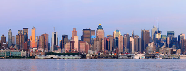 New York City Manhattan sunset panorama with historical skyscrapers over Hudson River viewed from New Jersey Weehawken waterfront at dusk with tranquil blue ton