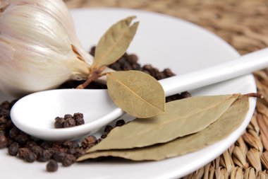 Bay list, garlic and black pepper peas in a white saucer clipart