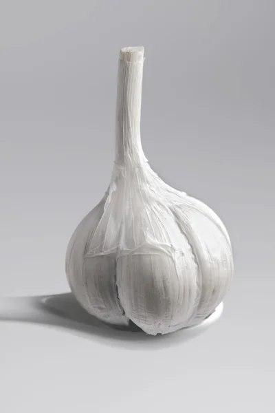 stock image Garlic in a white spoon.