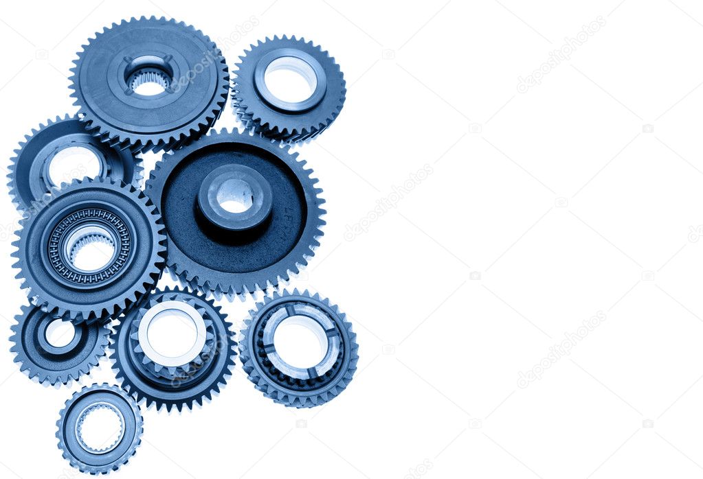 Steel gears meshing together on plain background