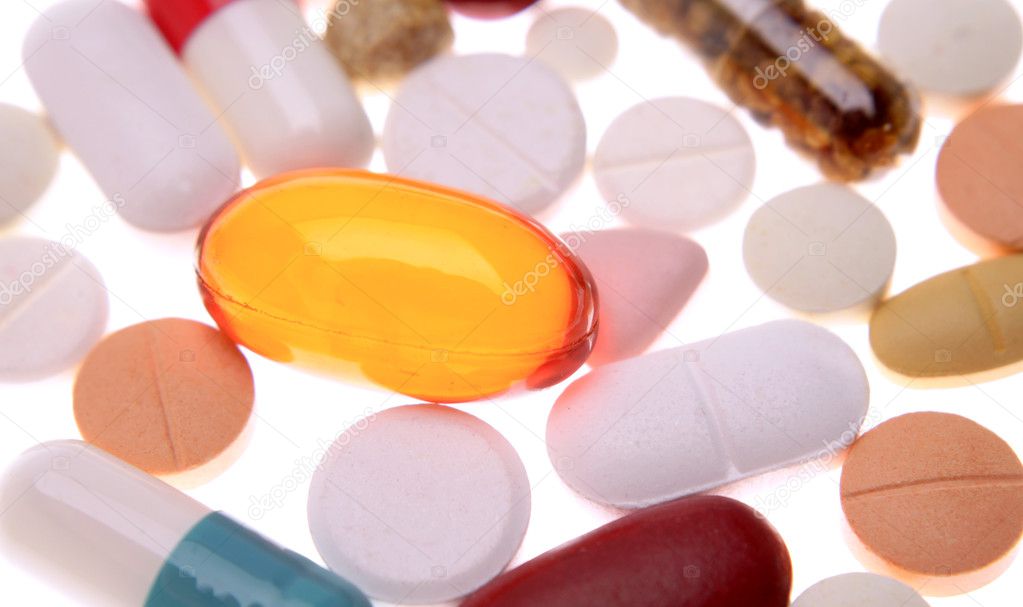 Closeup of assorted pills on white