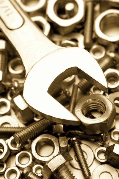 Closeup of spanner on nuts and bolts — Stock Photo, Image