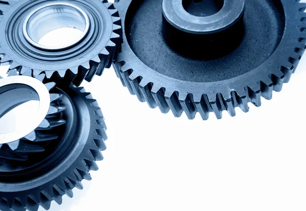 Closeup of steel gears meshing together on white — Stock Photo, Image