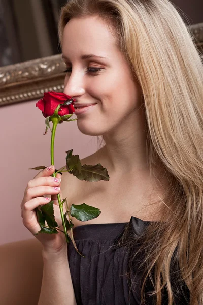 Radostné blondýnka s červenou růží — Stock fotografie