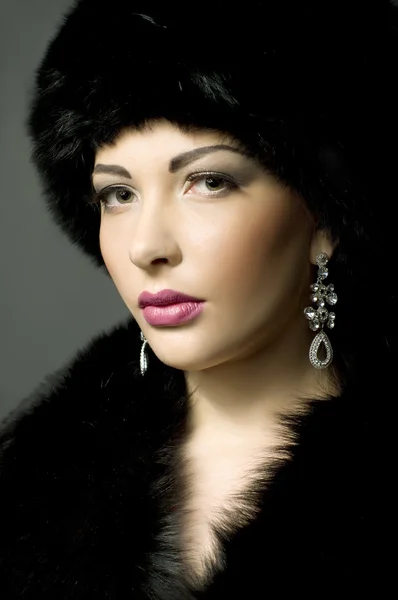 Beautiful young lady in black fur — Stock Photo, Image