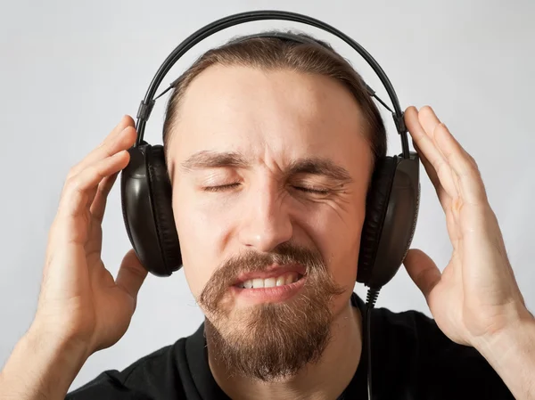 Jonge man in hoofdtelefoon met ogen dicht — Stockfoto