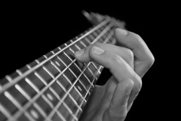 Fingers on guitar fretboard Royalty Free Stock Images