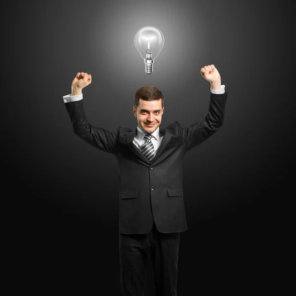Uomo d'affari testa di lampada con le mani in alto — Foto Stock