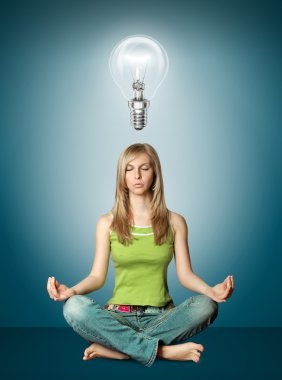 Woman meditation in lotus pose with bulb clipart