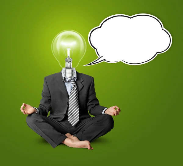 Lamp-head businessman in lotus pose with speech bubble — Stock Photo, Image
