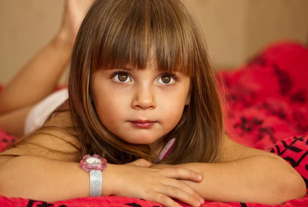 Adorable little girl in her bed — Stock Photo, Image