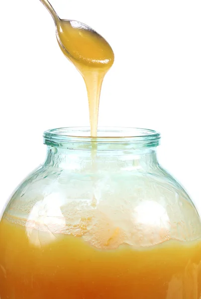 Honey jar and spoon — Stock Photo, Image
