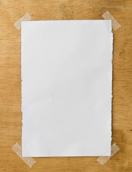 White paper on wooden wall — Stock Photo, Image