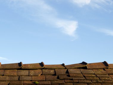 An Old Leaky Roof against Blue Sky clipart